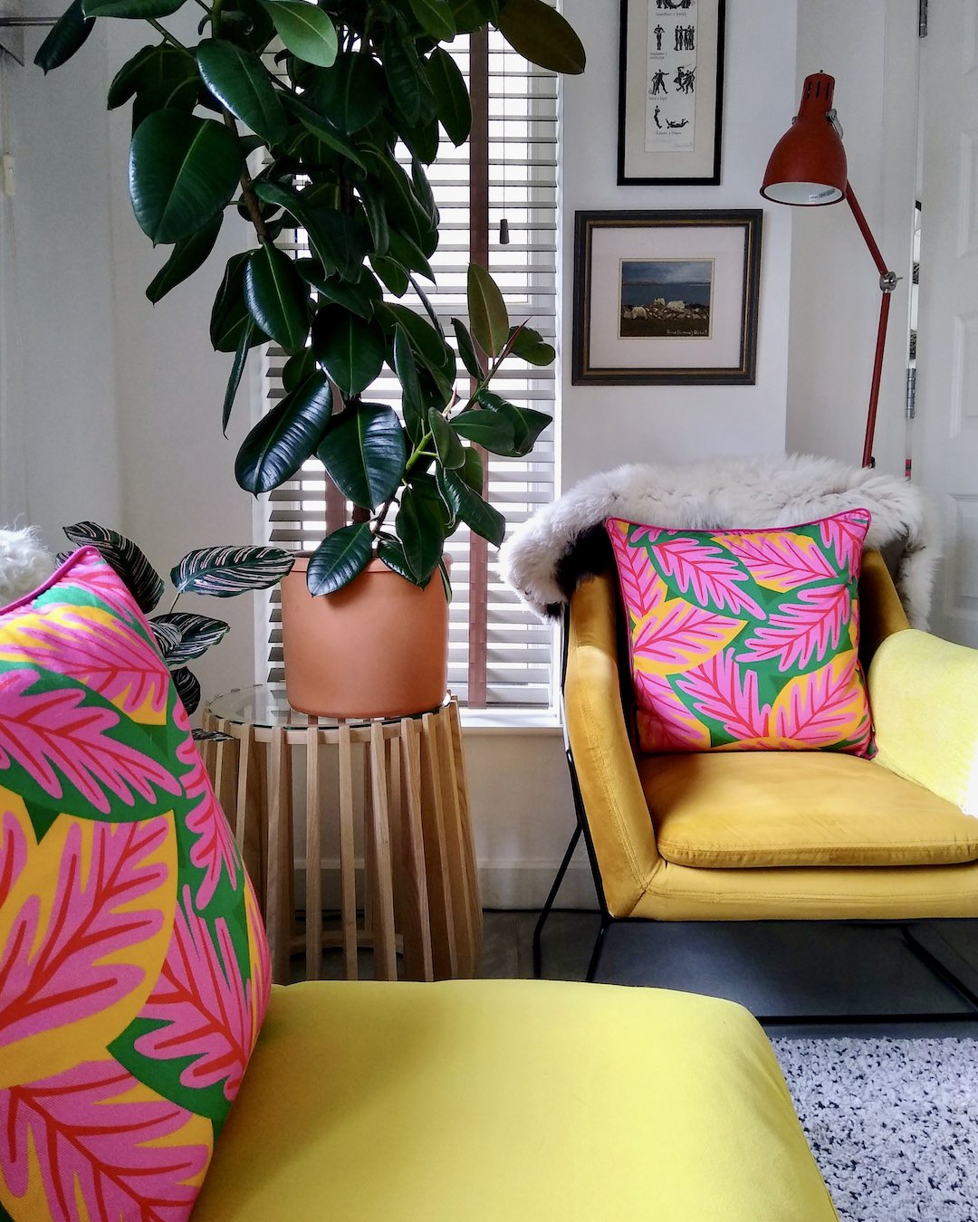 Customer photo of bright pink, yellow and green floral cushions on yellow chairs, showing how to add more colour to your home without redecorating