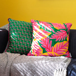 Colourful cushion cover duo on sofa with bold pink, yellow and green tropical leaves and geometric zigzag prints – Republic of Happy