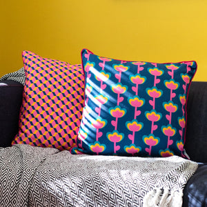 Colourful cushion cover duo on sofa with bold blue, pink and yellow graphic floral and geometric prints – Republic of Happy